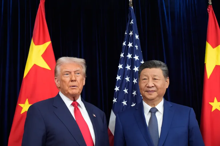 President Donald Trump, left, and Chinese President Xi Jinping, right, pose for photo before their US-China summit at Gimhae international airport in Busan, South Korea, on October 30, 2025 [Mark Schiefelbein/AP Photo]
